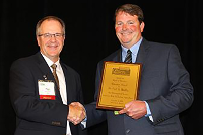 Dr. Carl Bradley, Extension Professor, recieved the  Mid-America CropLife Association (MACA) Educator of the Year award on September 10, 2019.  The award is presented to an individual who has demonstrated significant contributions to American agriculture, especially in the MACA region, and has demonstrated evidence of consistency in educating the public on the value of production agriculture. Presenting the award is MCAA president, Paul Edsten. 